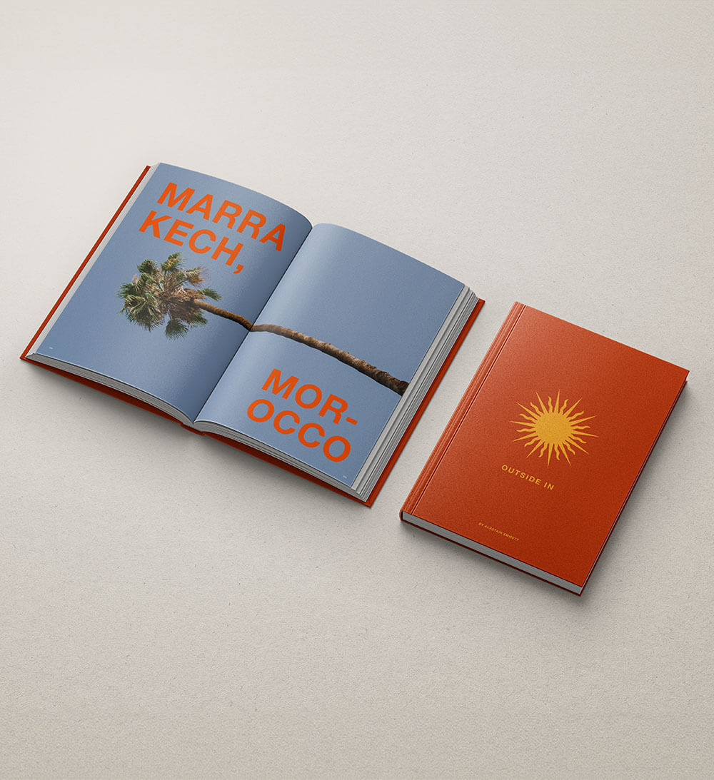 Open coffee table book featuring image of Marrakech and book cover design