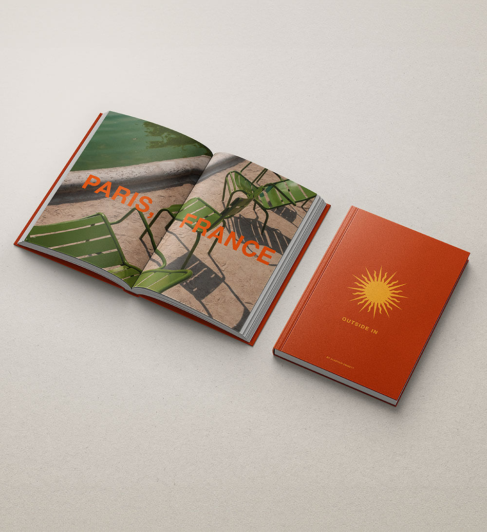 Open coffee table book featuring image of Paris and book cover design