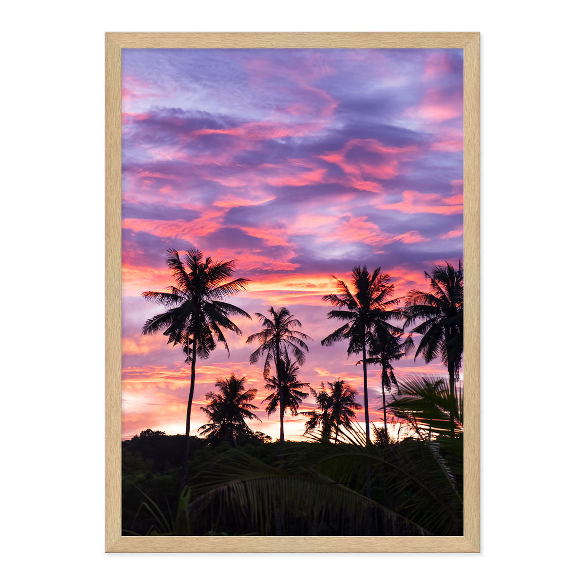 Framed artwork of palm trees against a vibrant purple and pink sunset sky.