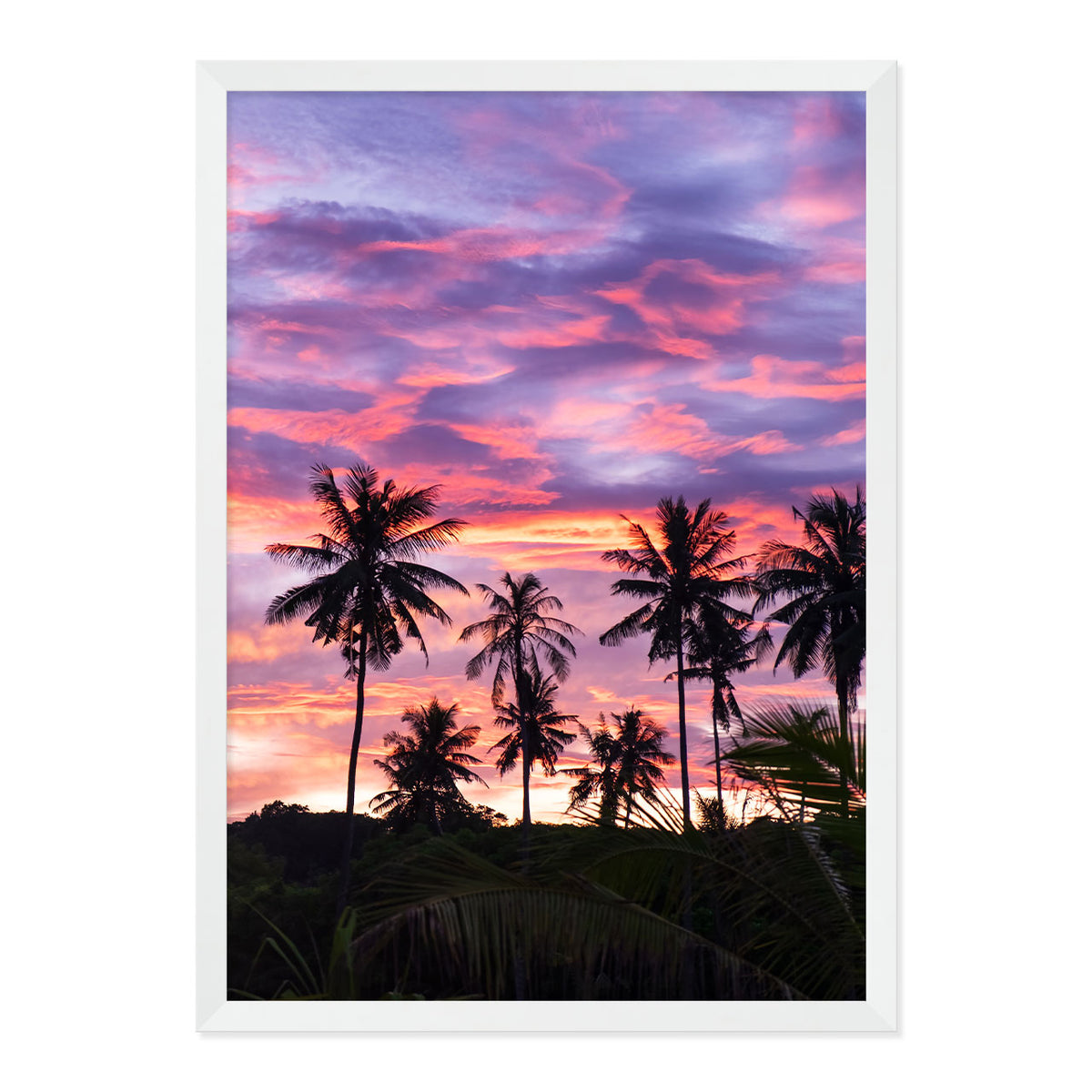 Framed artwork of palm trees against a vibrant purple and pink sunset sky.