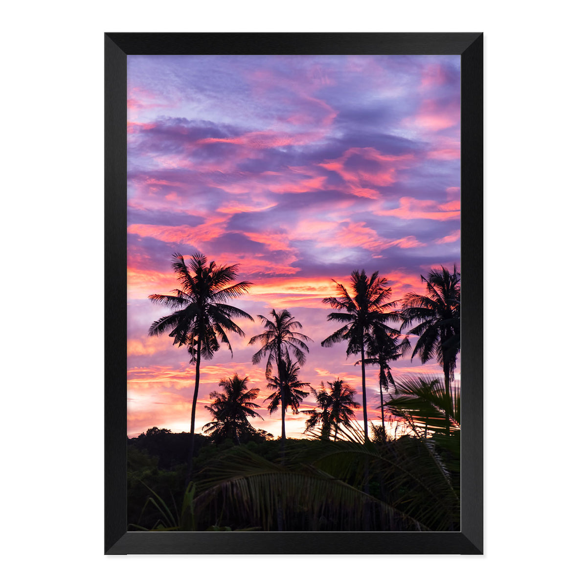 Framed artwork of palm trees against a vibrant purple and pink sunset sky.