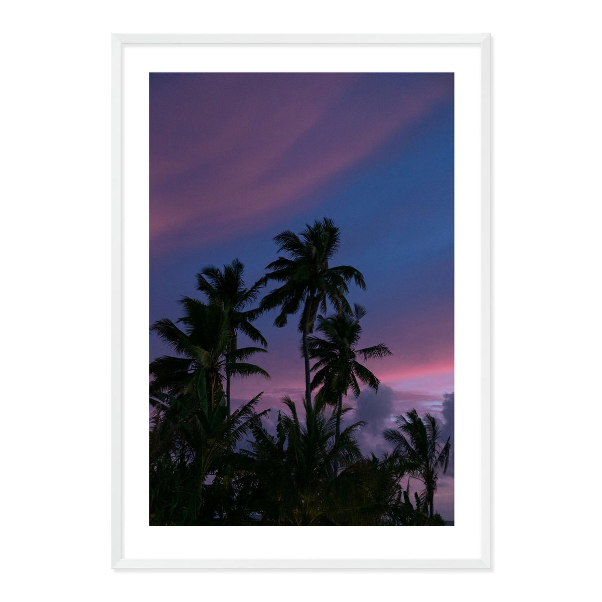 Framed artwork of palm trees against a purple sky