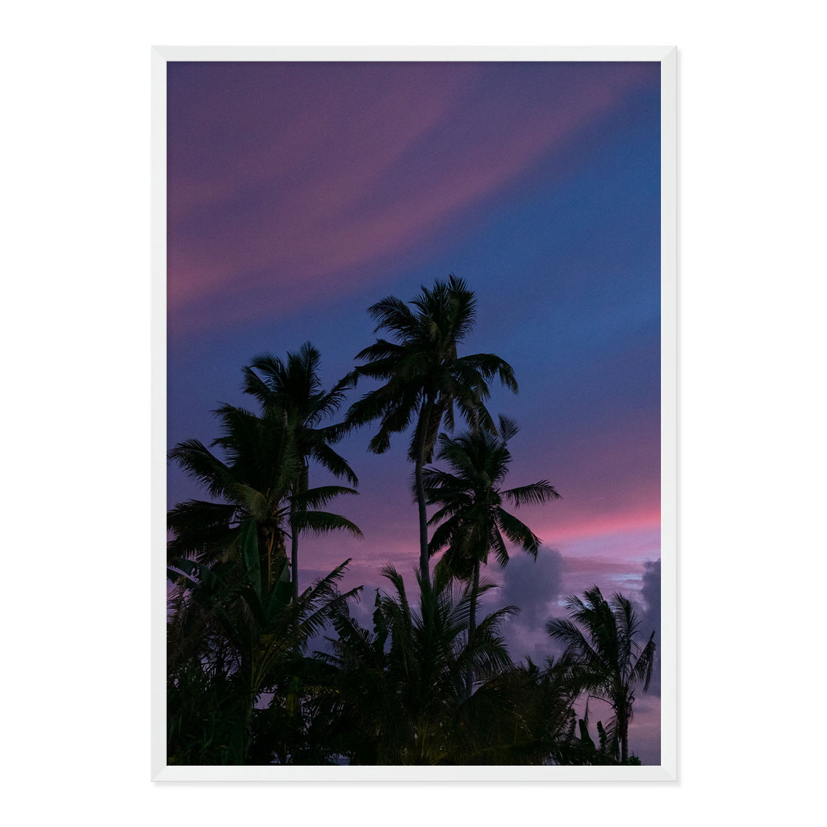 Framed artwork of palm trees against a purple sky