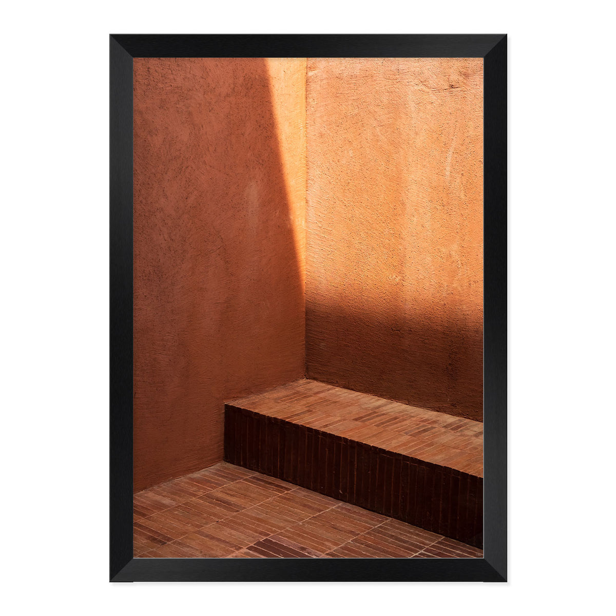 Framed photograph of a corner with wooden floor and wall, casting a shadow.